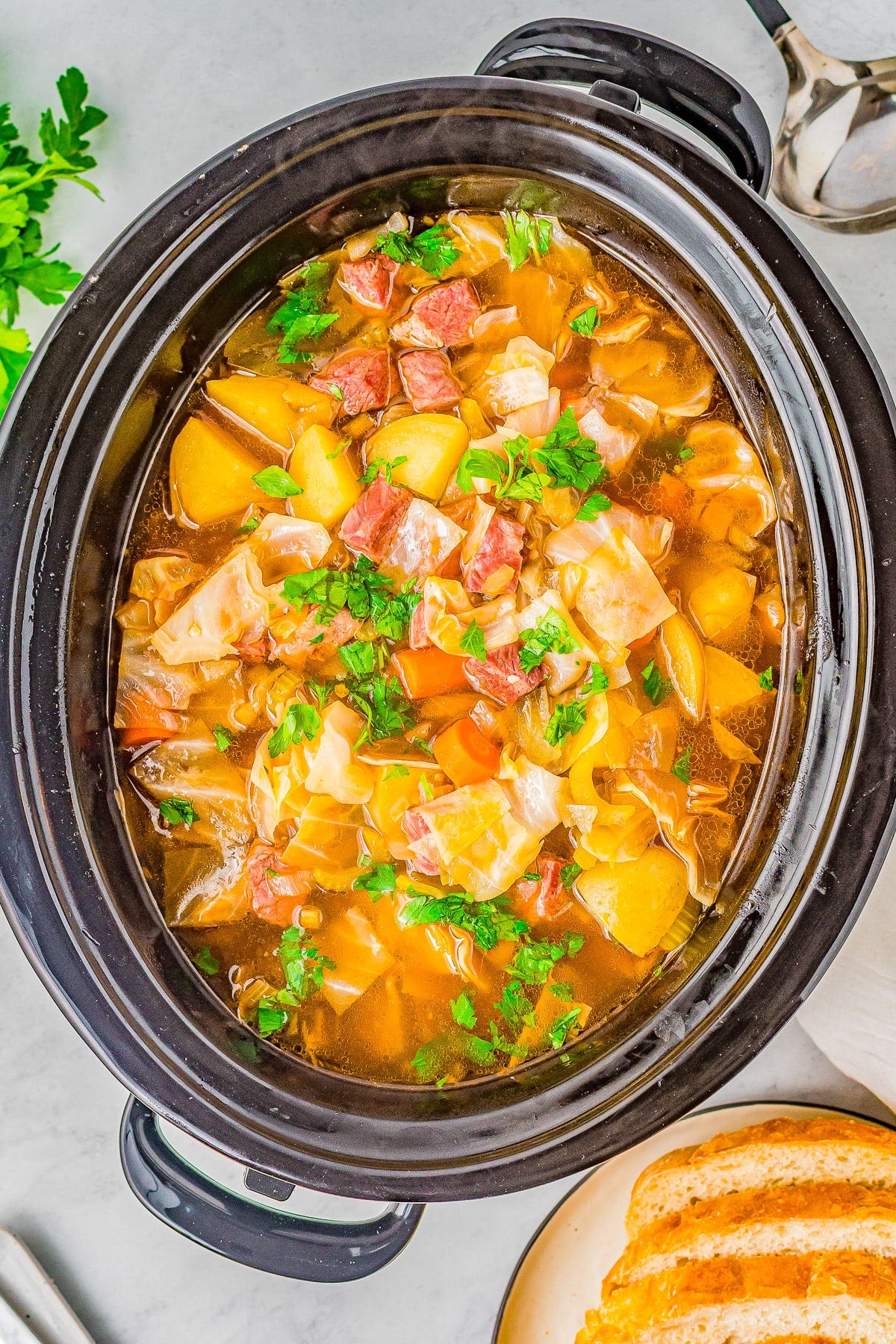 Slow Cooker Corned Beef and Cabbage Soup - Hearty comfort food complete with savory corned beef, potatoes, carrots, celery, and more! It's the EASIEST soup you'll ever make and will become a family FAVORITE especially when the weather is chilly! Stovetop cooking instructions also provided.