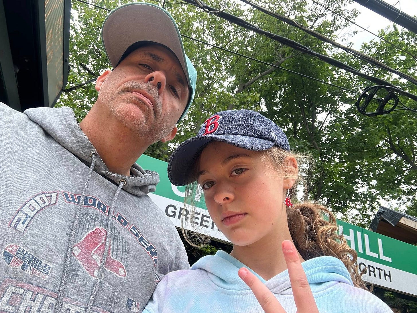 May be an image of 2 people, people smiling, hat and text