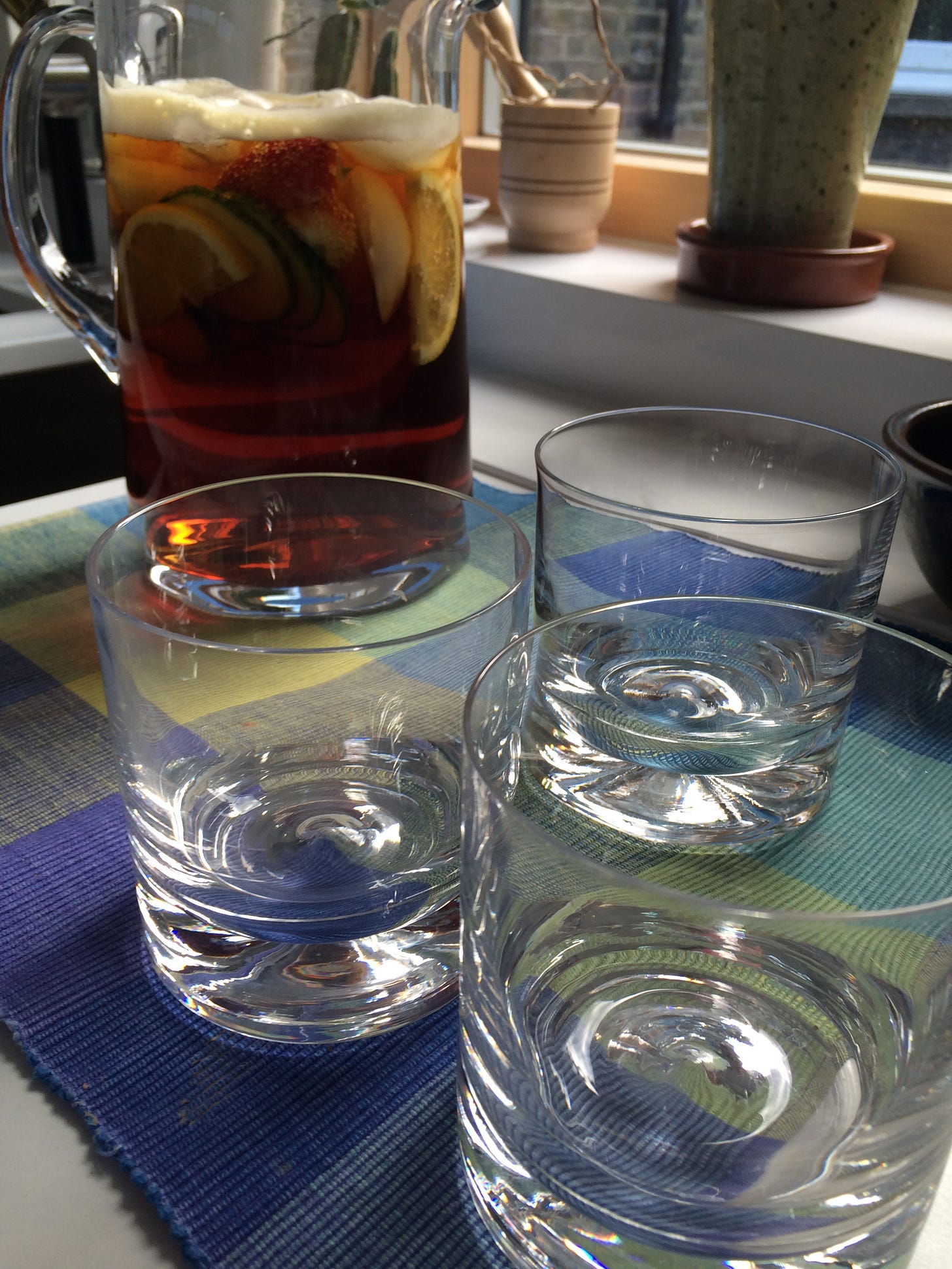 A jug of Pimm's and three glasses.