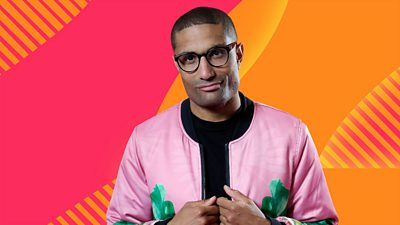 Richie Anderson wearing a pink jacket half smiling in front of the Radio 2 bright orange and pink graphics background