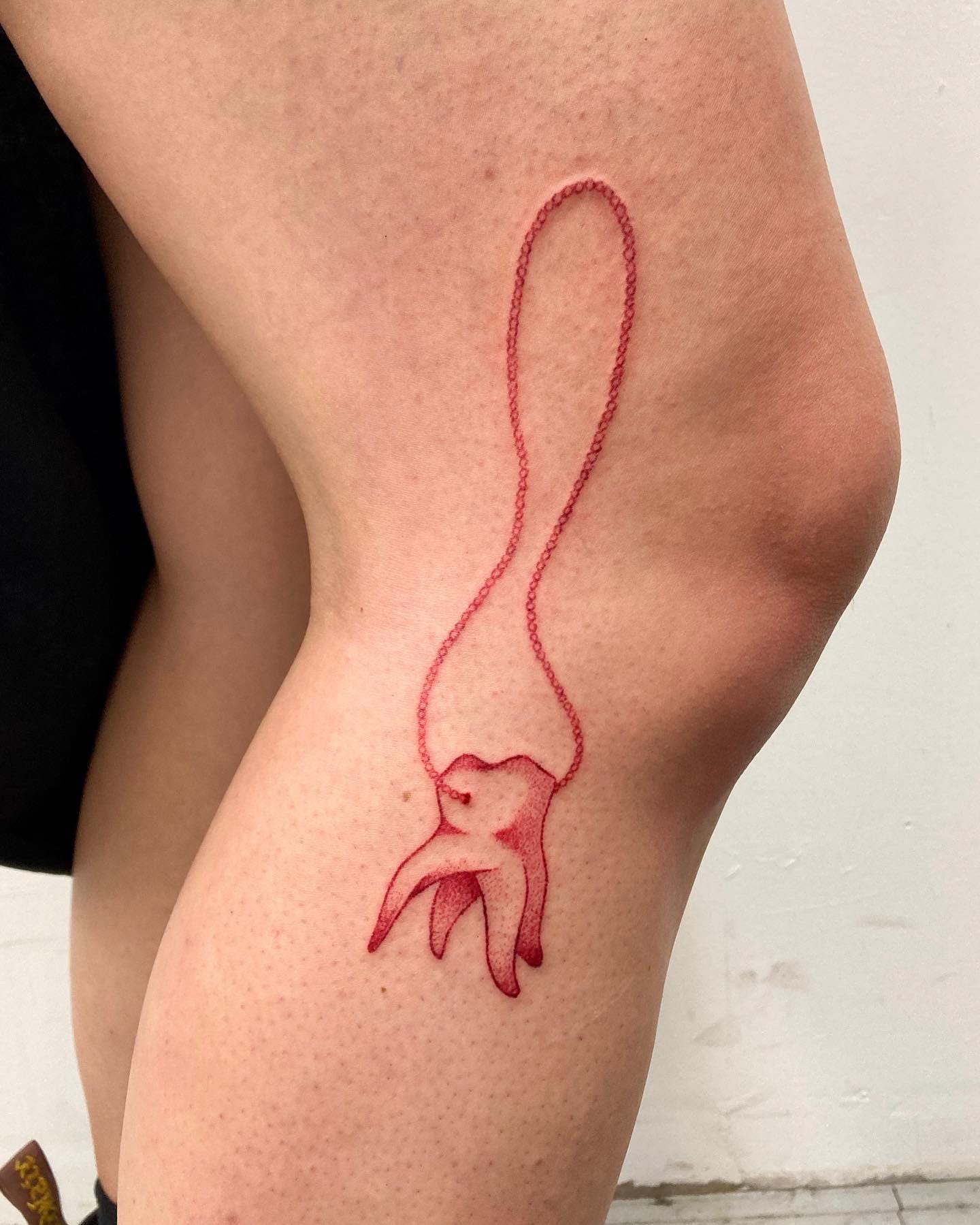 tooth on a string tattoo