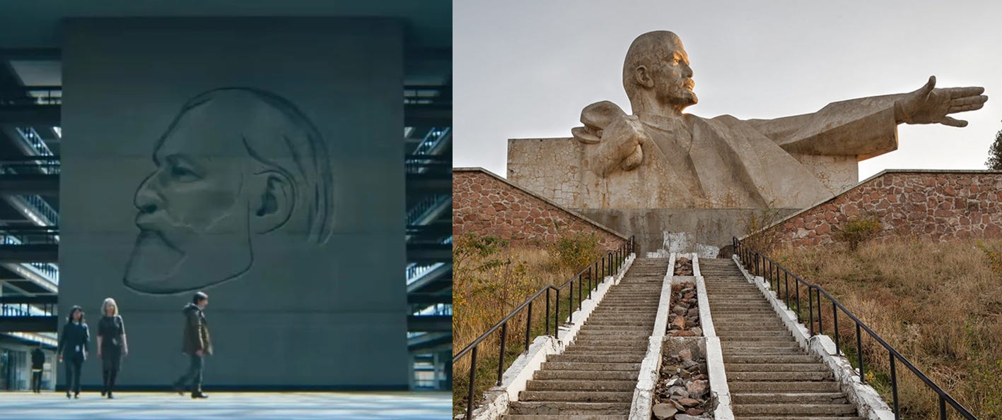 Left: Mark walking past an engraved portrait of Kier Eagan. The portrait is of Kier Eagan's face in profile, carved into a massive stone slab. Right: Monument to Lenin, Istaravshad, Tajikistan. The sculpture is in the brutalist style, with sharp lines and angles. It's a massive bust of Lenin atop a hill with stairs leading up to it - Lenin's reaching one arm out, imposingly, and with his other hand is holding his cap. It's angled so that when you're walking up the stairs you see Lenin's face in profile. Left: Mark walking past an engraved portrait of Kier Eagan. The portrait is of Kier Eagan's face in profile, carved into a massive stone slab. Right: Monument to Lenin, Istaravshad, Tajikistan. The sculpture is in the brutalist style, with sharp lines and angles. It's a massive bust of Lenin atop a hill with stairs leading up to it - Lenin's reaching one arm out, imposingly, and with his other hand is holding his cap. It's angled so that when you're walking up the stairs you see Lenin's face in profile.