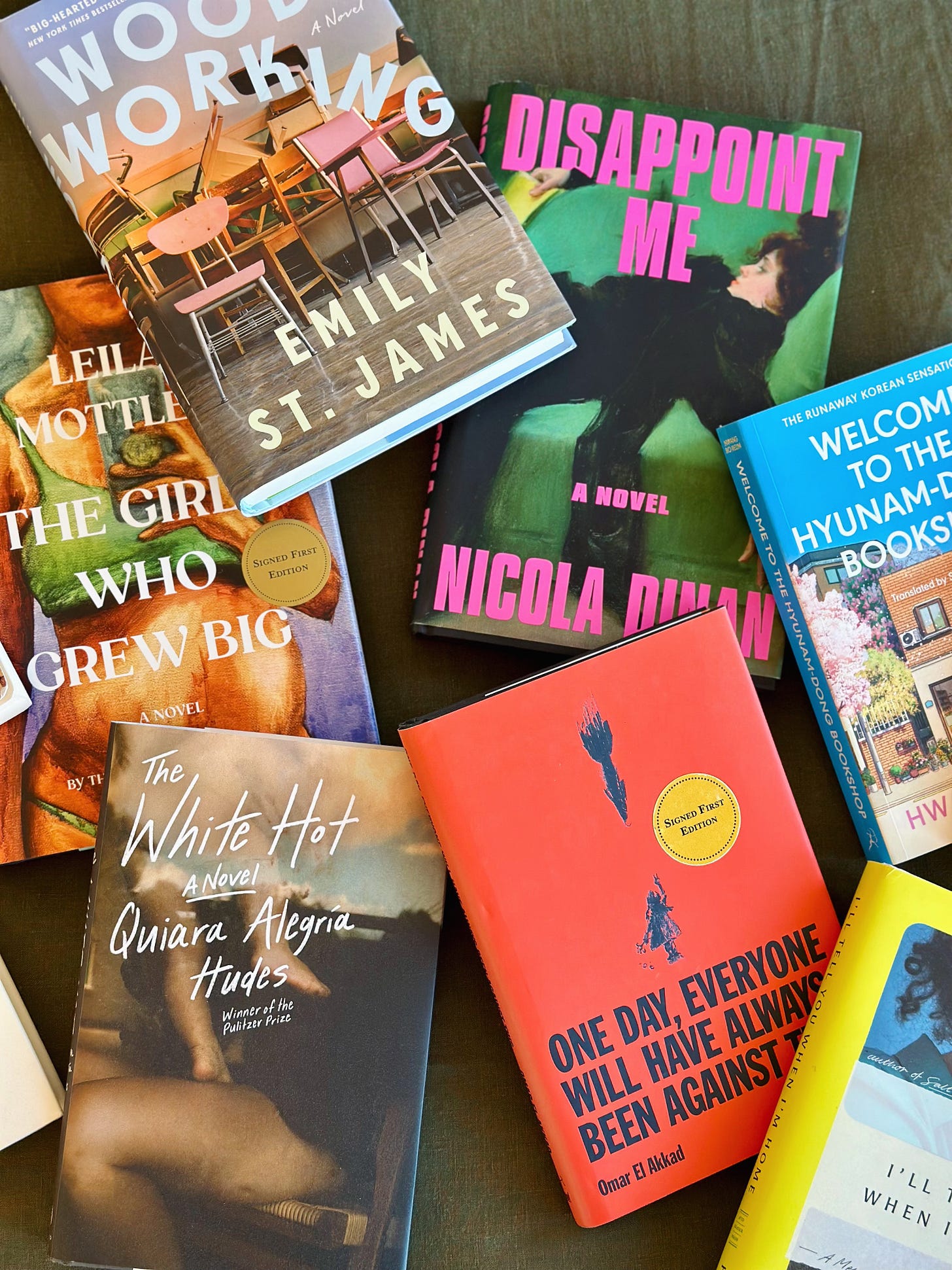 A flatlay of books on a green blanket