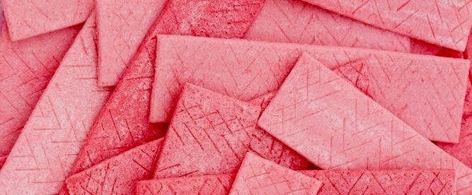 This may contain: a pile of pink crayon paper on top of each other