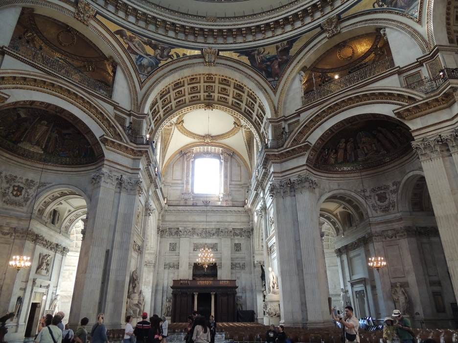 A large ornate building with many columns with St. Peter's Basilica in the background

AI-generated content may be incorrect.