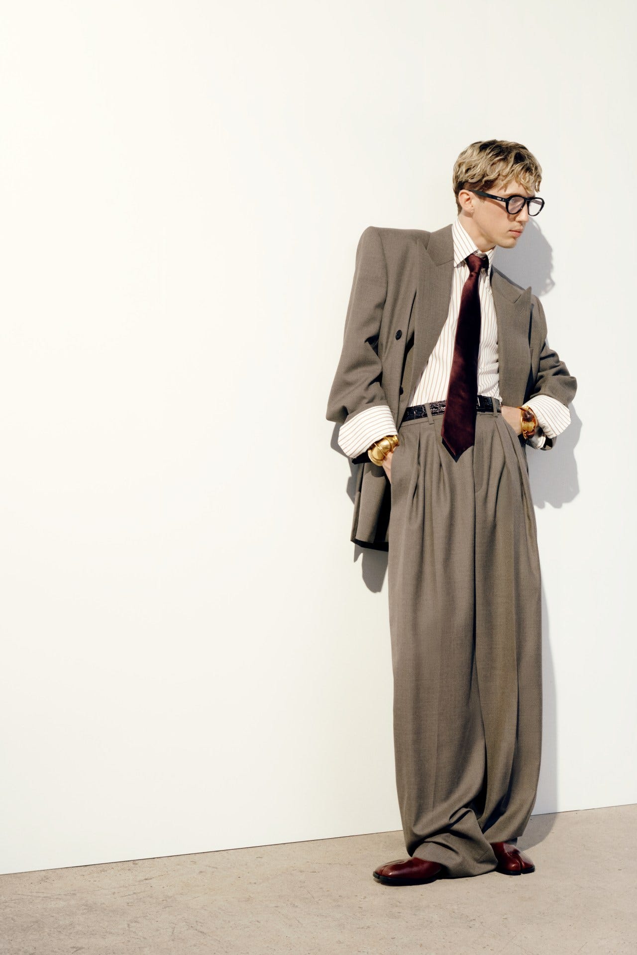 Saint Laurent suit, Gentle Monster Glasses, Maison Margiela shoes.