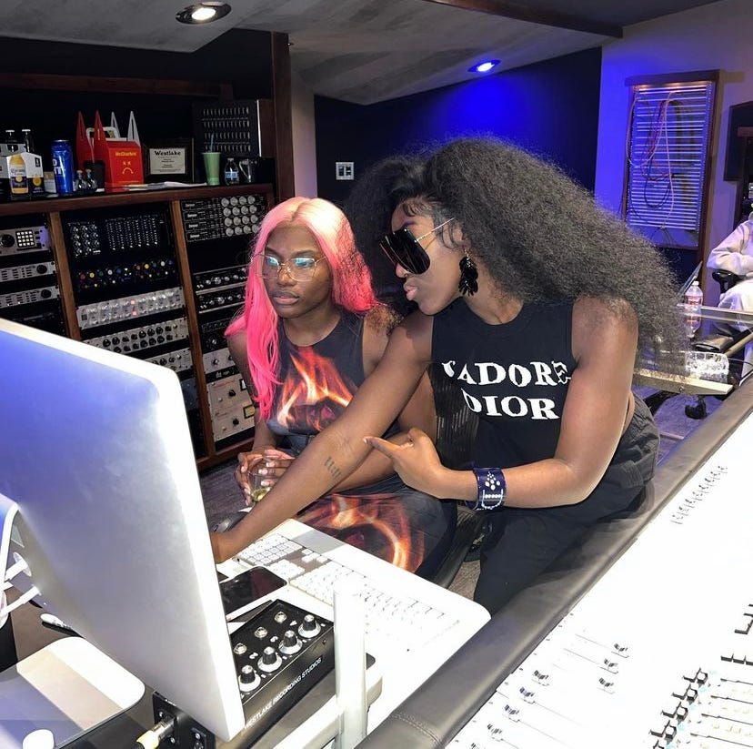 Photo of Doechii wearing pink and blonde hair and Bree Runway wearing long kinky hair blown out while in the studio. Photo of Doechii wearing pink and blonde hair and Bree Runway wearing long kinky hair blown out while in the studio.