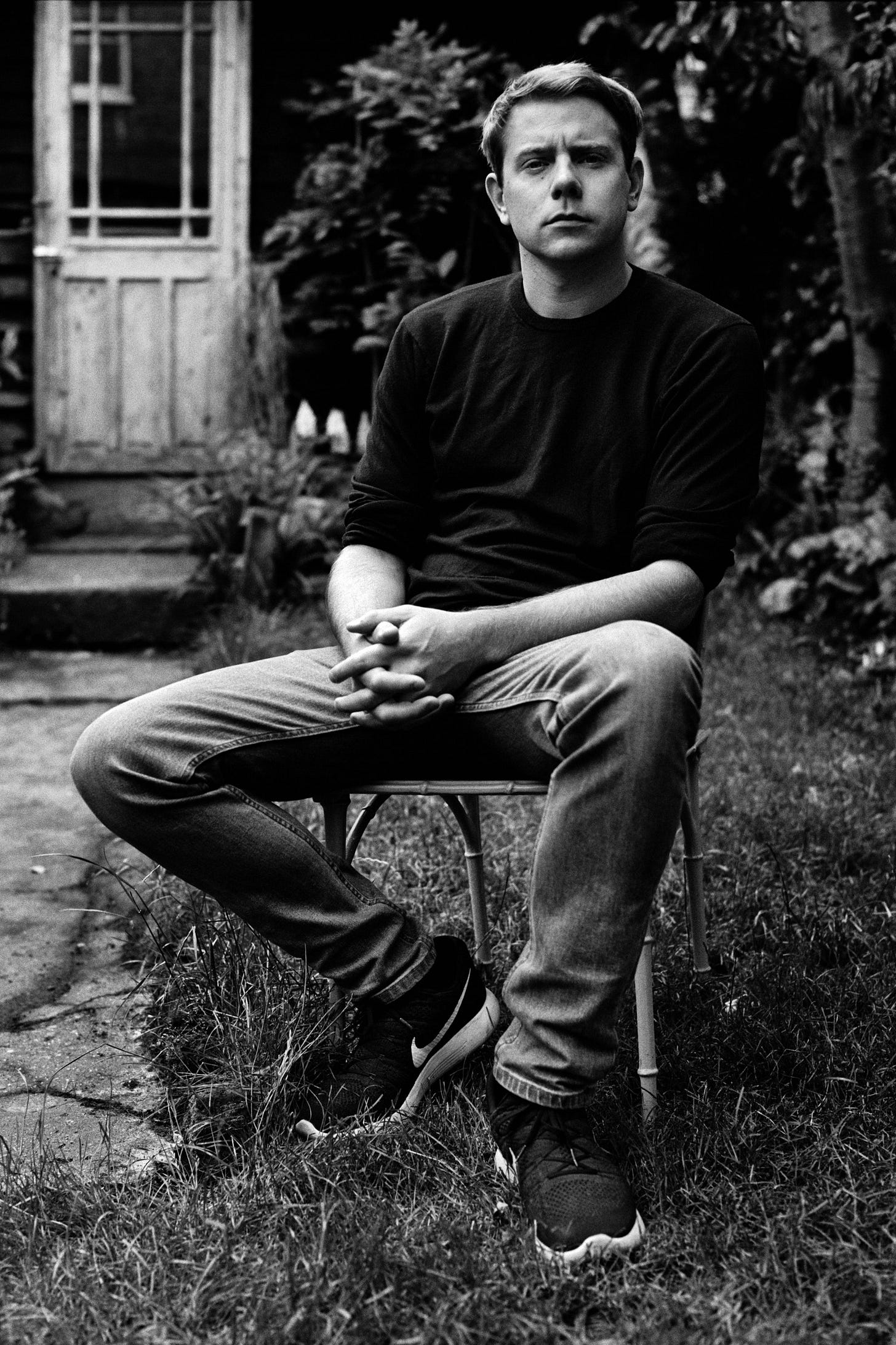 Image may contain Person Sitting Face Head Photography Portrait Body Part Finger Hand Adult Clothing and Footwear