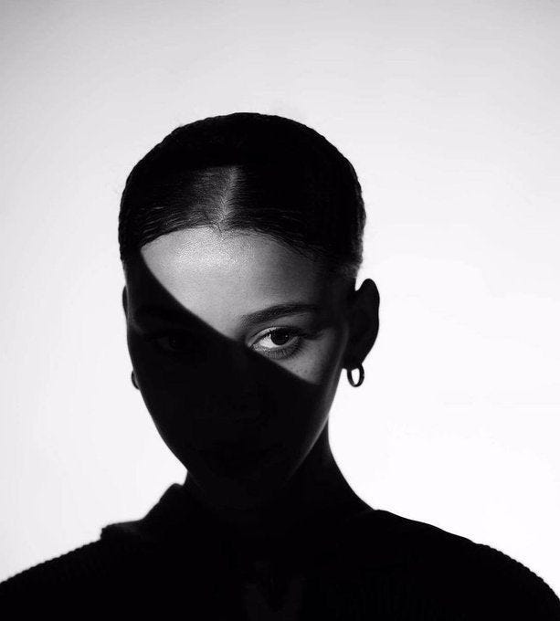 This may contain: a black and white photo of a woman's face with her shadow on the wall This may contain: a black and white photo of a woman's face with her shadow on the wall