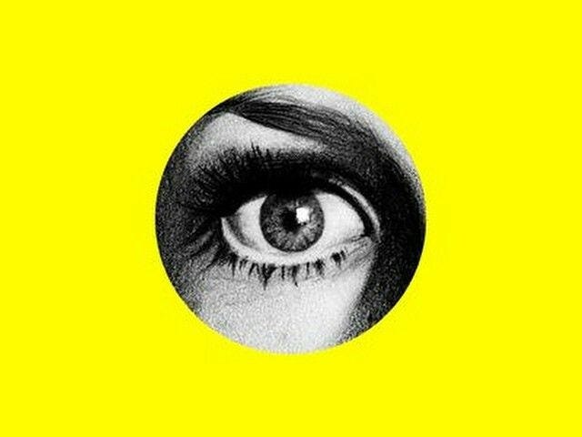 This may contain: an eye with long eyelashes is shown in black and white on a yellow paper background This may contain: an eye with long eyelashes is shown in black and white on a yellow paper background