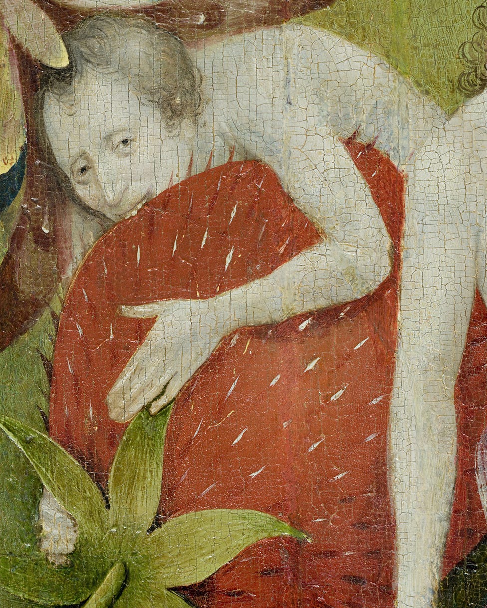 A naked man eats a strawberry the size of an armchair with his teeth. His eyes are... expressive.