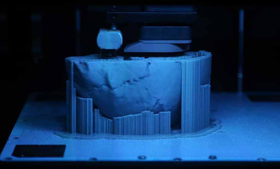 3D printer with a half-printed skull visible