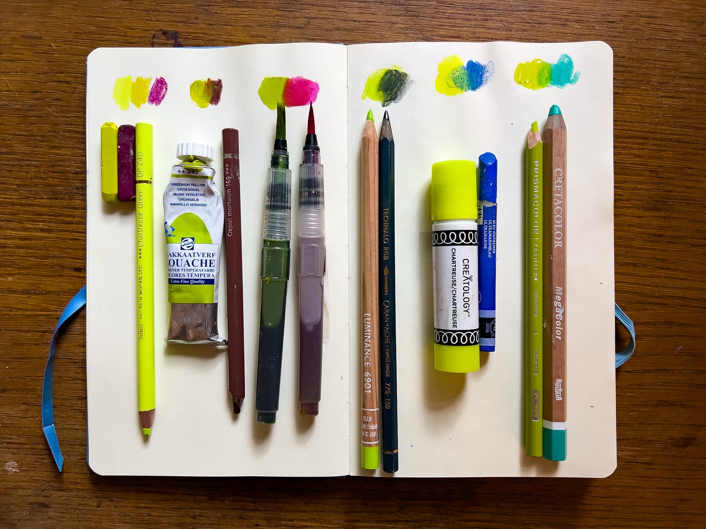 Chartreuse pencils and paints and various colors to mix it with