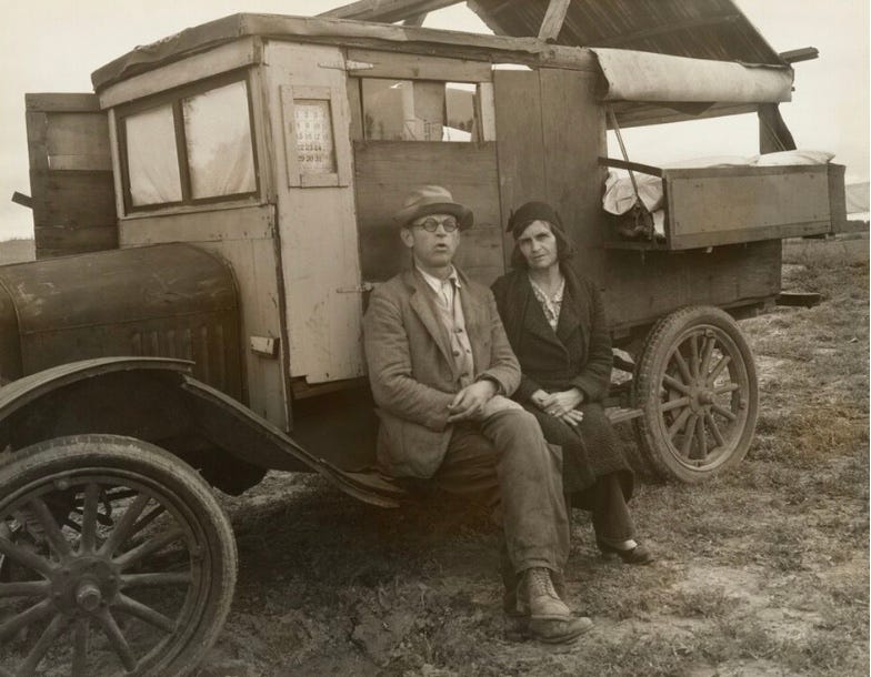 Migrant farmworkers by their home made van in 1936