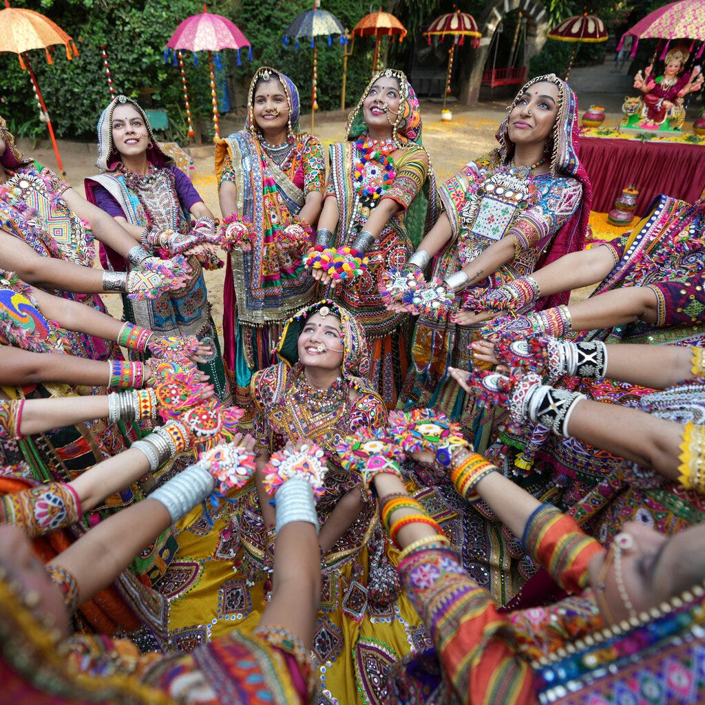 Women dancing in colorful bracelets. 