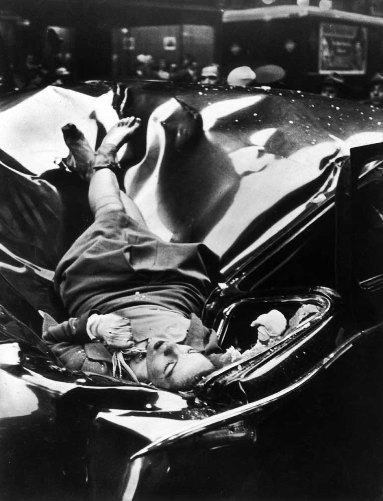 The body of 23-year-old Evelyn McHale rests atop a crumpled limousine minutes after she jumped to her death from the Empire State Building, May 1, 1947. Source.