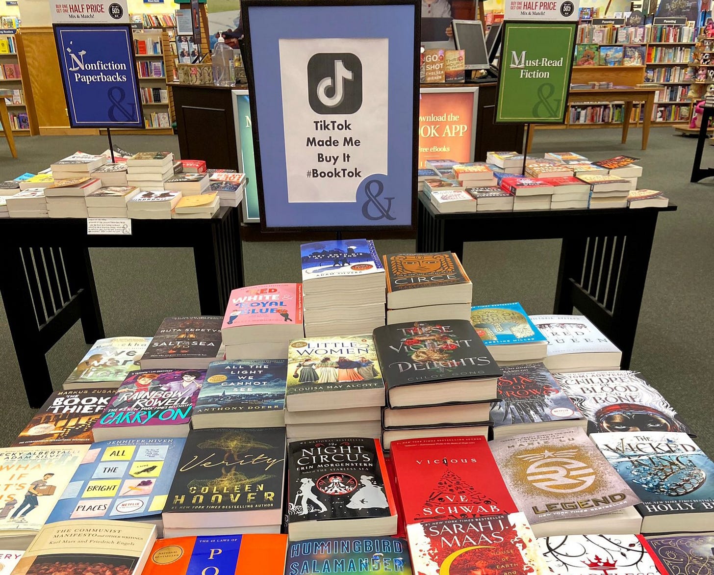 A table in a bookstore with a sign that says "TikTok made me buy it"