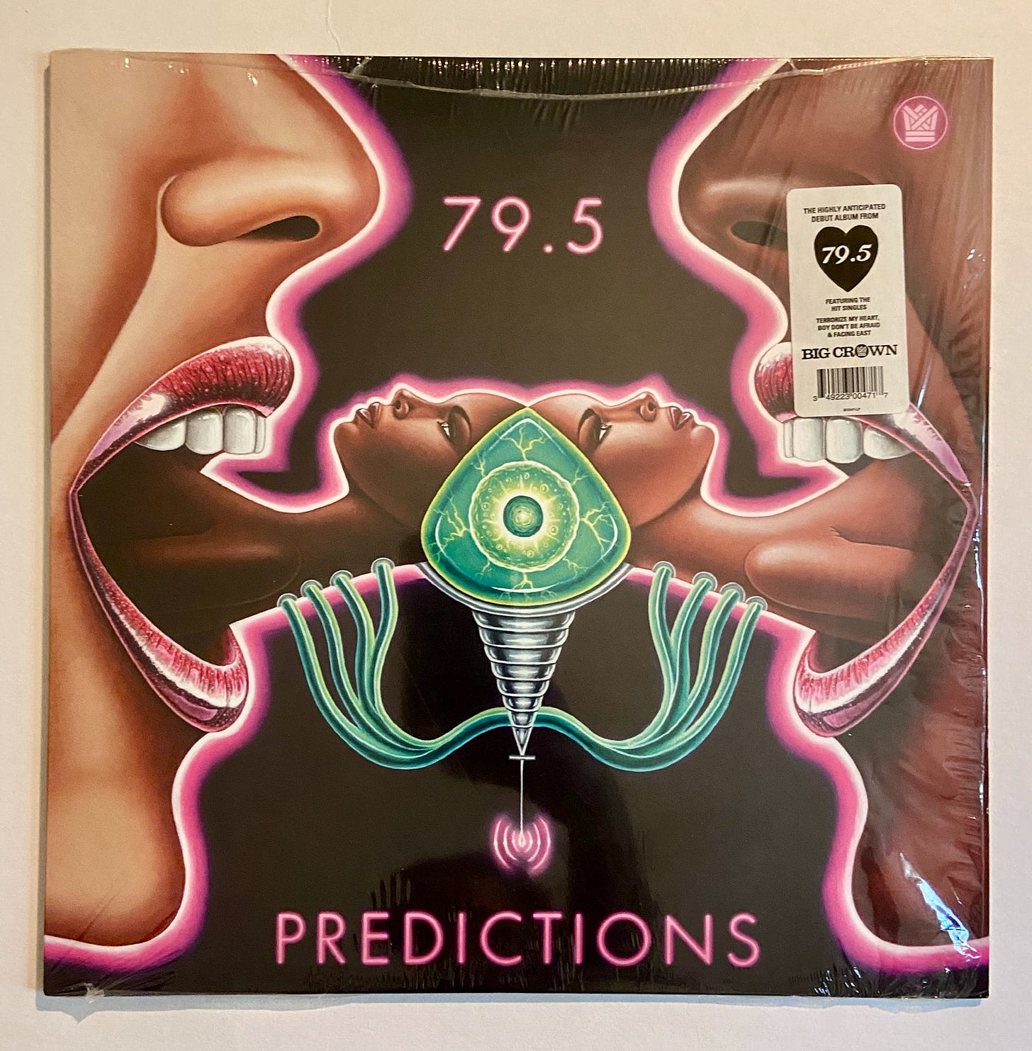 a trippy image of multiracial women with other women protruding from their mouths. they are surrounded by a pink glow and the band name 79.5, as well as the album title "Predictions" appear in pink neon text. the record is still in shrink wrap with a promotional sticker on it. a trippy image of multiracial women with other women protruding from their mouths. they are surrounded by a pink glow and the band name 79.5, as well as the album title "Predictions" appear in pink neon text. the record is still in shrink wrap with a promotional sticker on it.