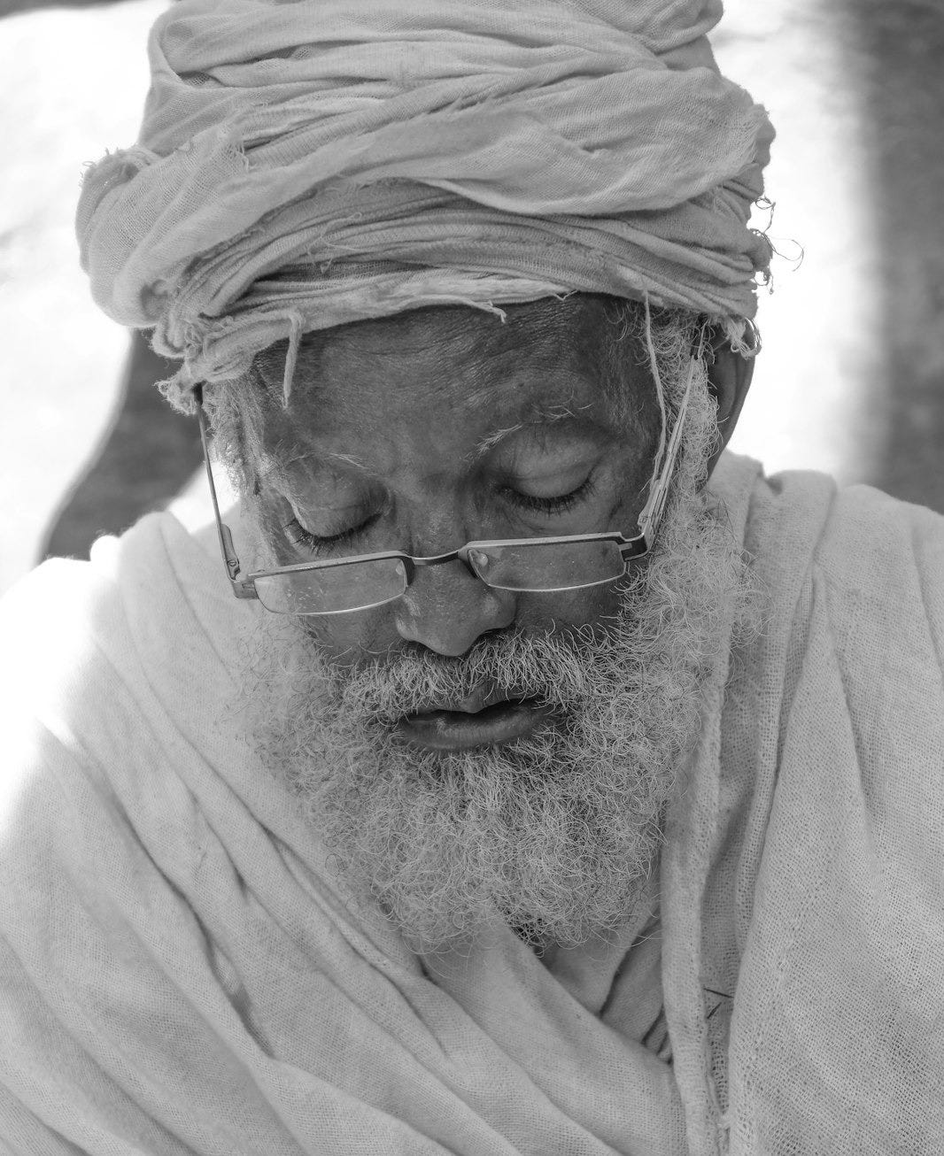 grayscale photo of man wearing eyeglasses grayscale photo of man wearing eyeglasses