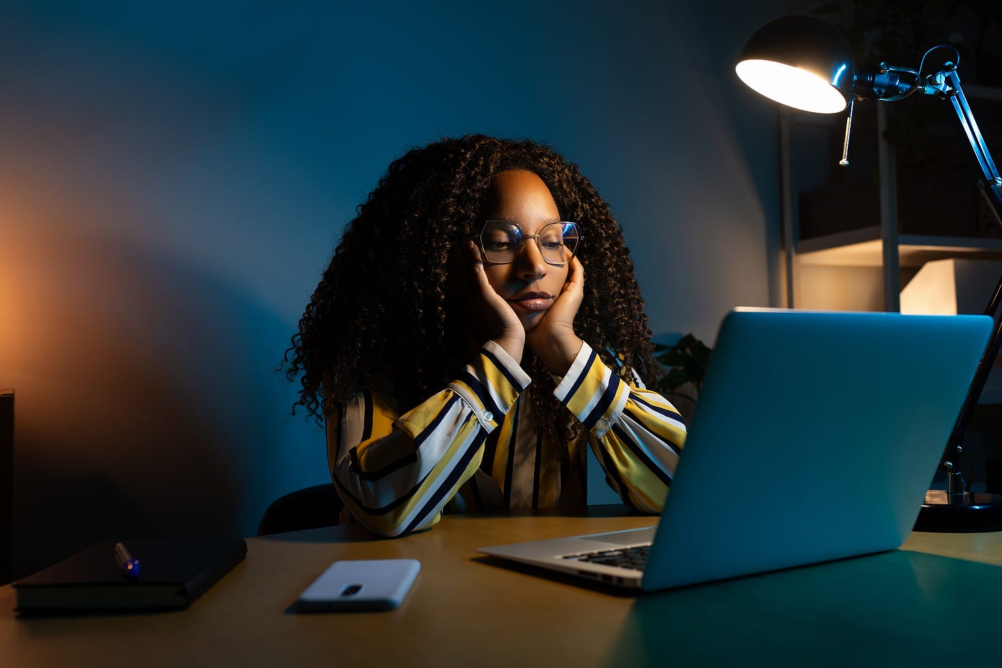 black girl sleepily looks at computer