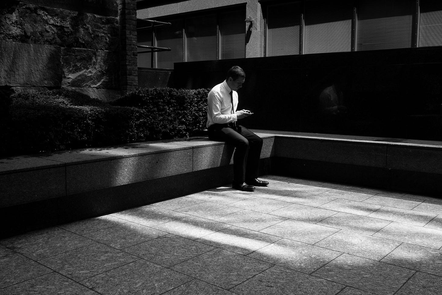 London, 2015. A man sites alone in a bit of sun.
