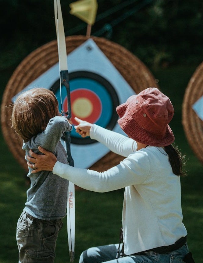 boy holding white bow