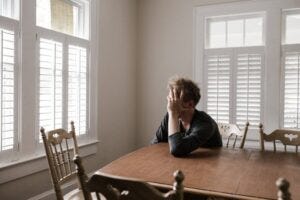 unhappy man at dinner table unhappy man at dinner table