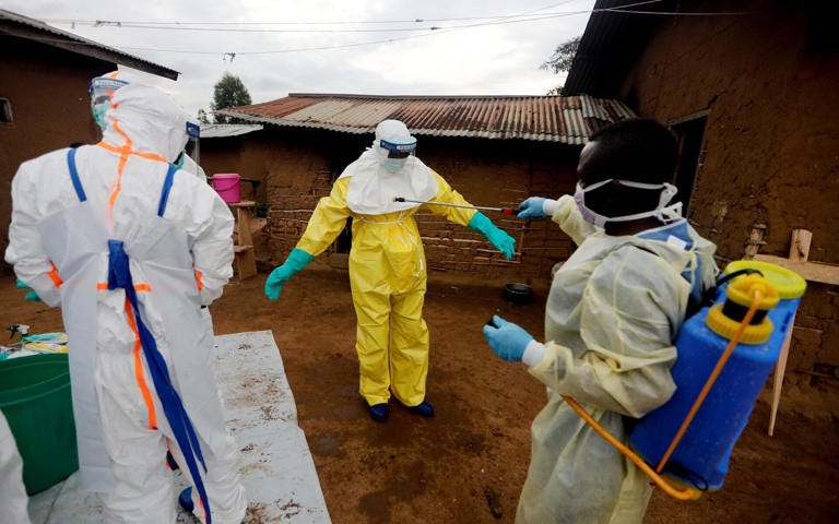 Healthcare workers decontaiminate a colleage during an outbreak in the DRC - REUTERS/Zohra Bensemra Healthcare workers decontaiminate a colleage during an outbreak in the DRC - REUTERS/Zohra Bensemra