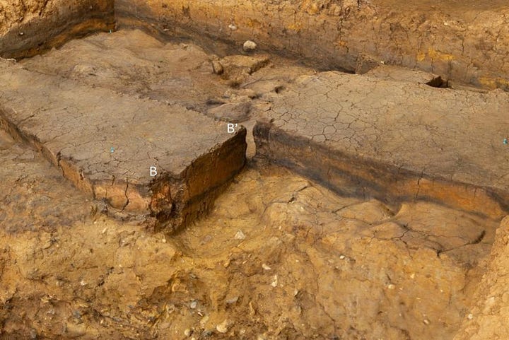 Excavation of 400,000-year-old pond sediments at Barnham, England; an ancient campfire site, with reddened sediment indicating heated clay.Credit...Jordan Mansfield/Pathways to Ancient Britain Project