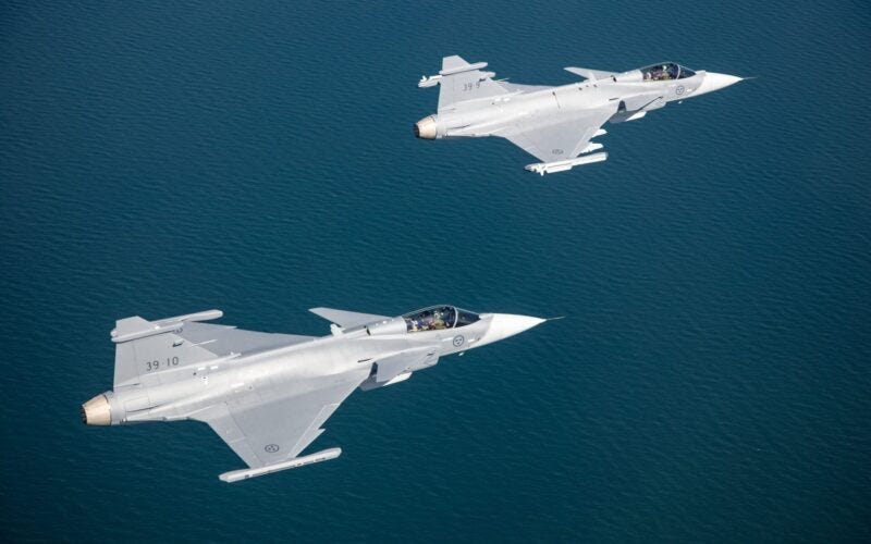 Two Saab Gripen E fighter jets flying in formation Two Saab Gripen E fighter jets flying in formation