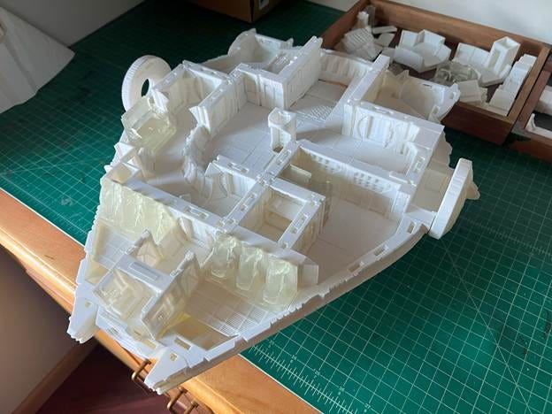 A model of a house on a cutting mat

AI-generated content may be incorrect.