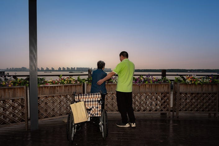 A health care worker helps support an elderly woman at a nursing home in Nanjing on June 11, 2019. Photo: VCG