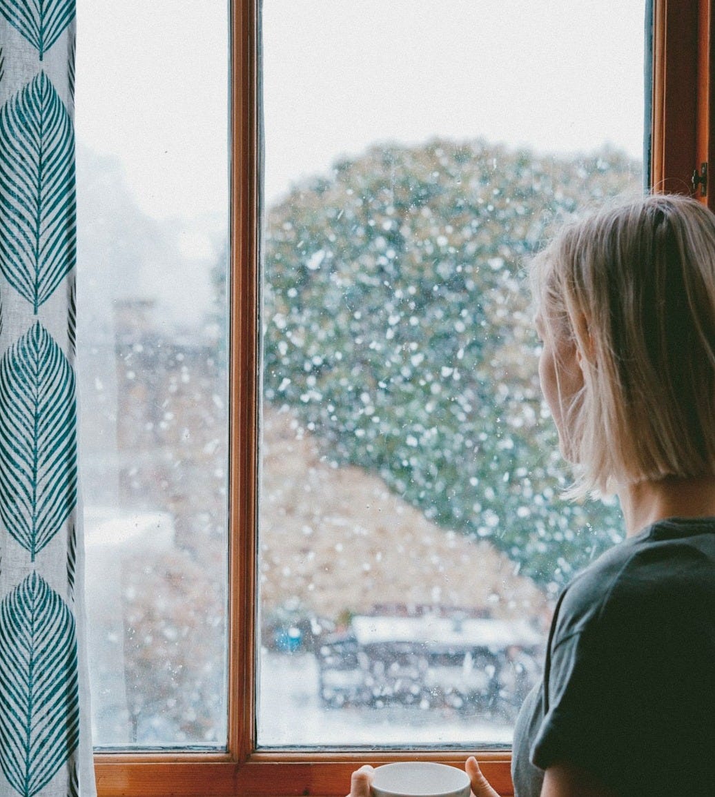 woman standing in front of clear glass window woman standing in front of clear glass window