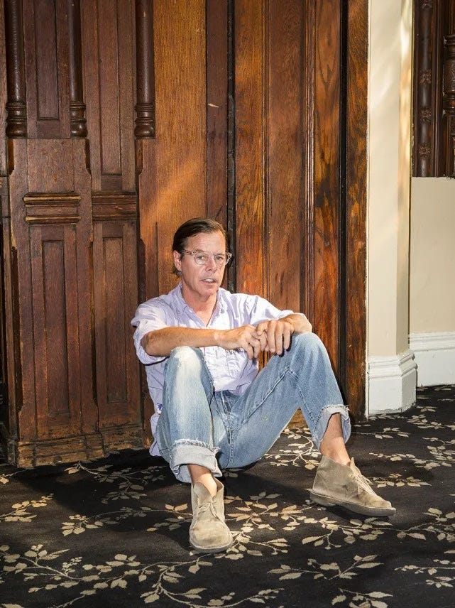 Andy Spade sitting casually wearing Clarks desert boots with a relaxed effortless style