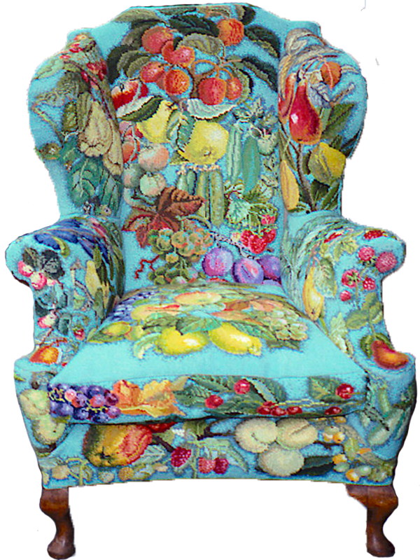 an armchair covered in needlepoint with a bright blue background and assorted fruit and vegetable motifs