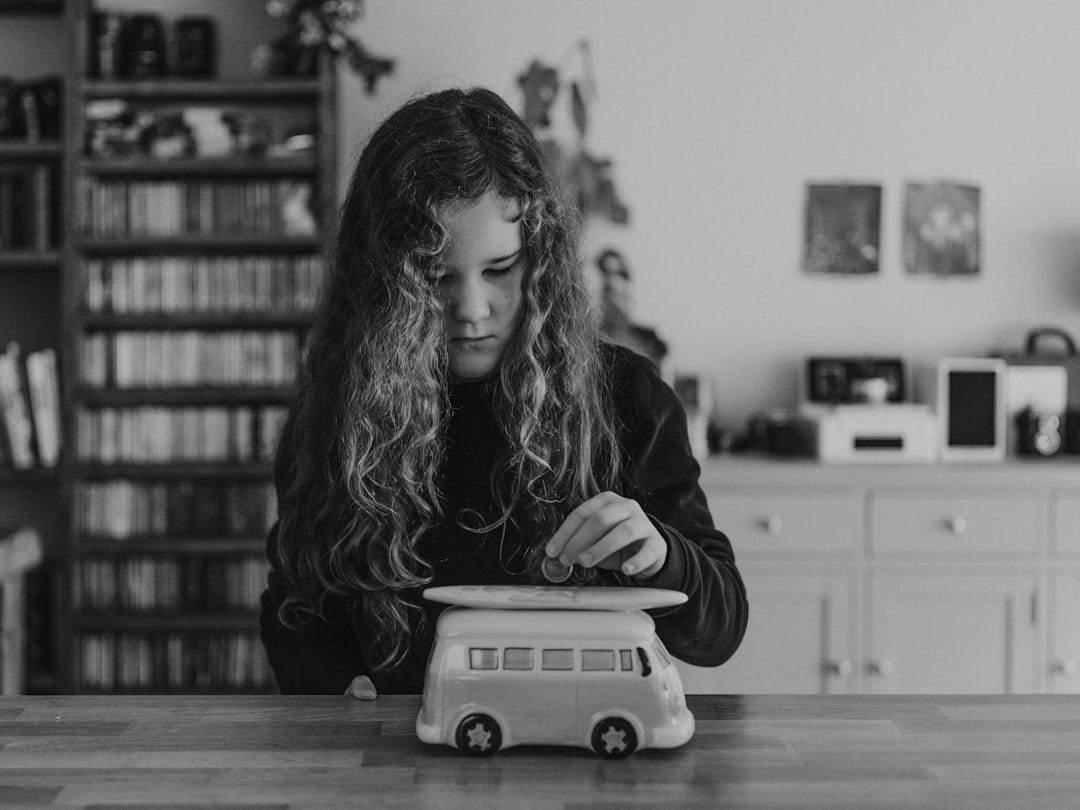 girl wearing black sweatshirt playing toy car girl wearing black sweatshirt playing toy car