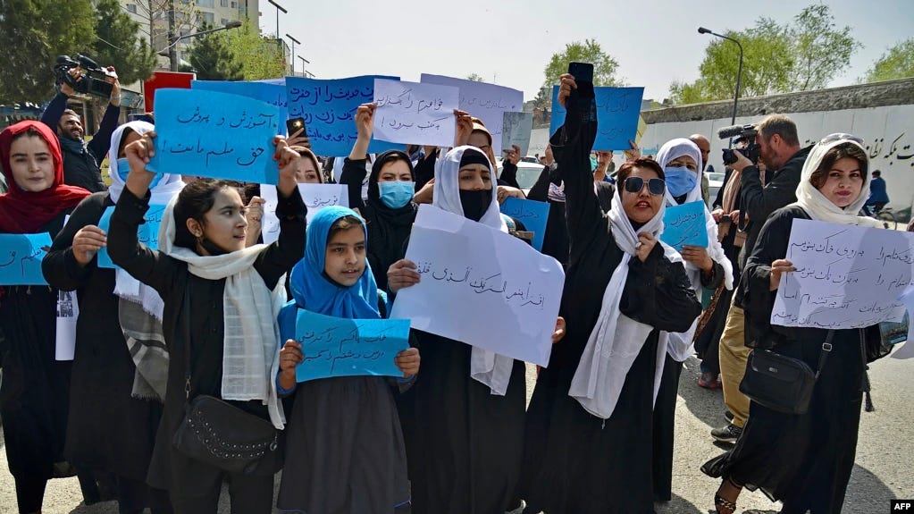 A group of people holding signs

Description automatically generated with medium confidence