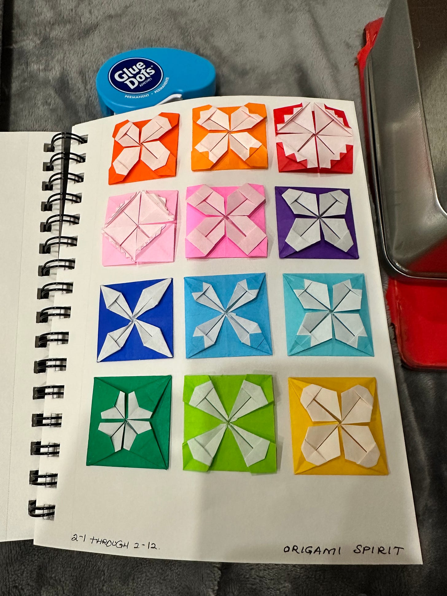 colorful origami patterns pasted neatly in a sketchbook