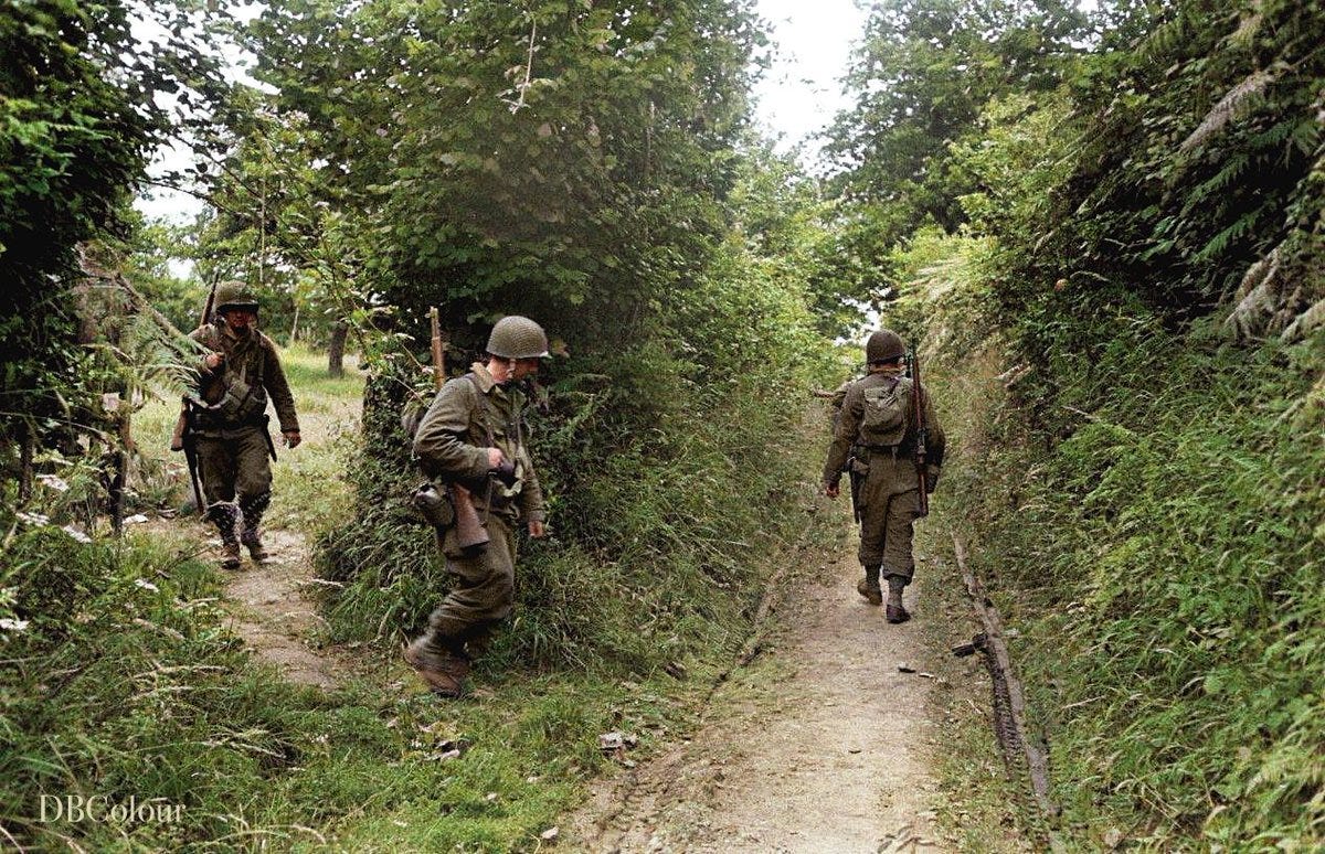 US soldiers walking though the Normandy Bocage on the way to Coutances,  France. July 1944 (Photo by Ralph Morse for 'Life' magazine)
