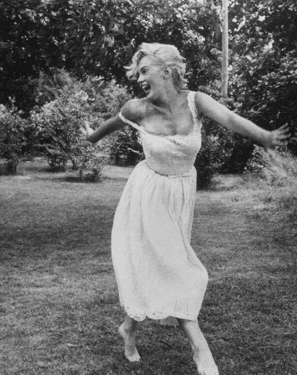 This may contain: an old photo of a woman jumping in the air