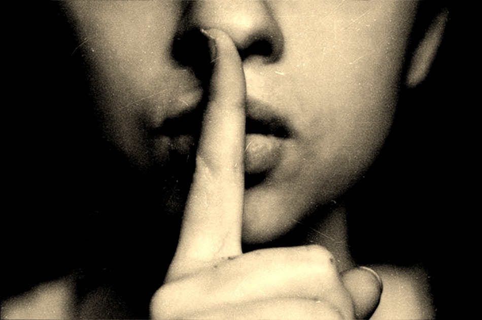 grayscale photo of woman doing silent hand sign grayscale photo of woman doing silent hand sign