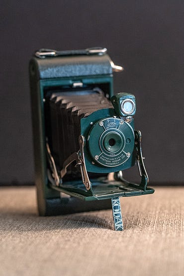 A photograph of an antique green camera