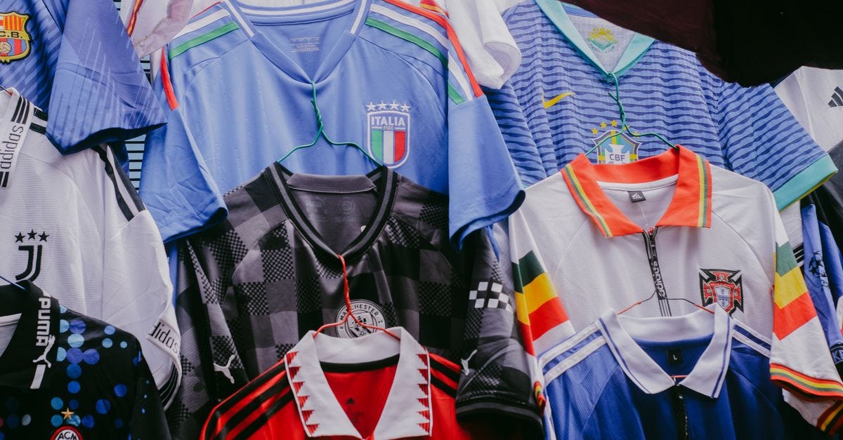 Various vintage soccer jerseys hanging on display, showcasing international teams' designs.