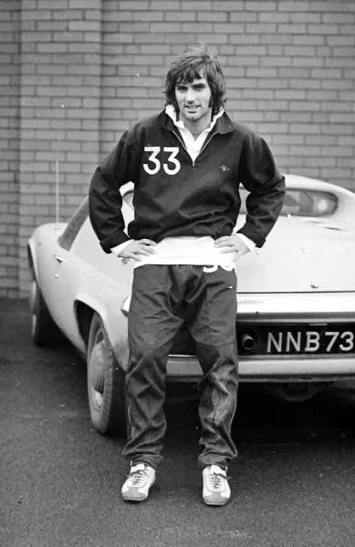 Manchester United star George Best poses next to his Lotus