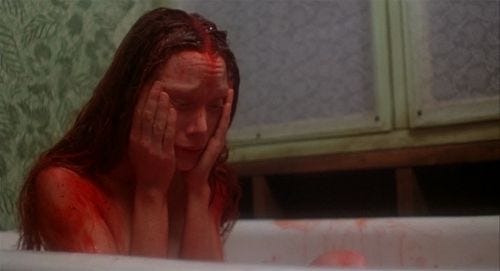 This may contain: a woman is sitting in the bathtub with her hands on her face