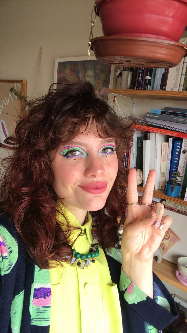 Left: Larissa in a green and pink and purple look (matching eyeshadow/eyeliner). Right: Larissa in a primary color look (also matching eyeshadow/eyeliner).