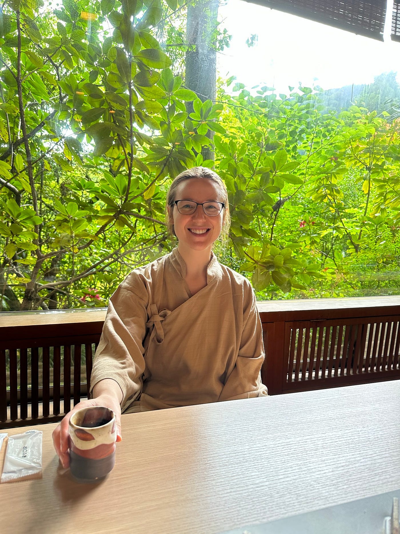 Mari-Alina Timoshchuk at a Japanese traditional inn with a forest in the background