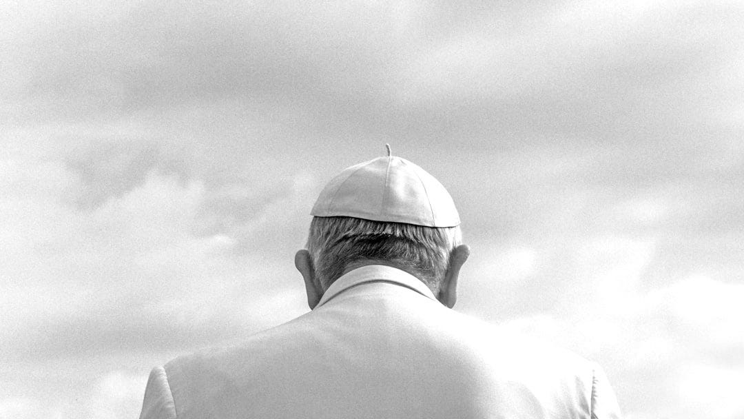 person wearing white cap looking down under cloudy sky during daytime person wearing white cap looking down under cloudy sky during daytime