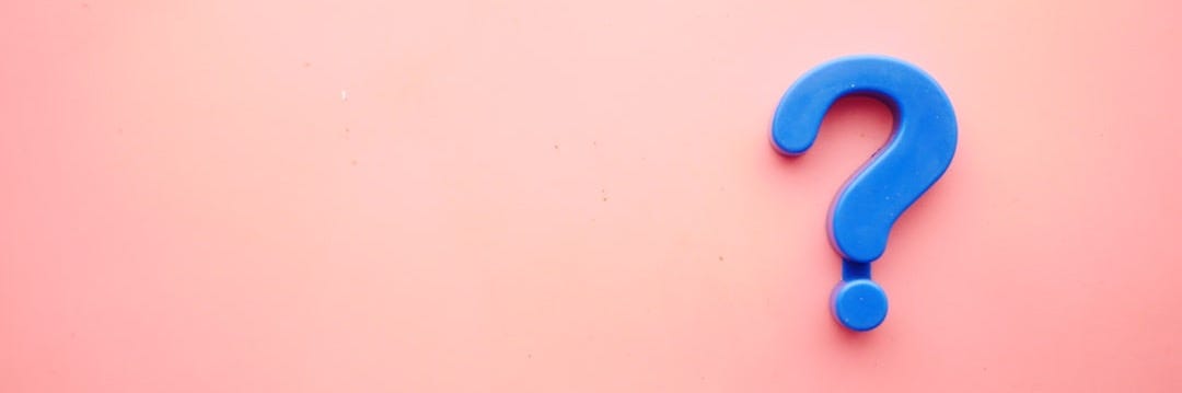 a blue question mark on a pink background a blue question mark on a pink background