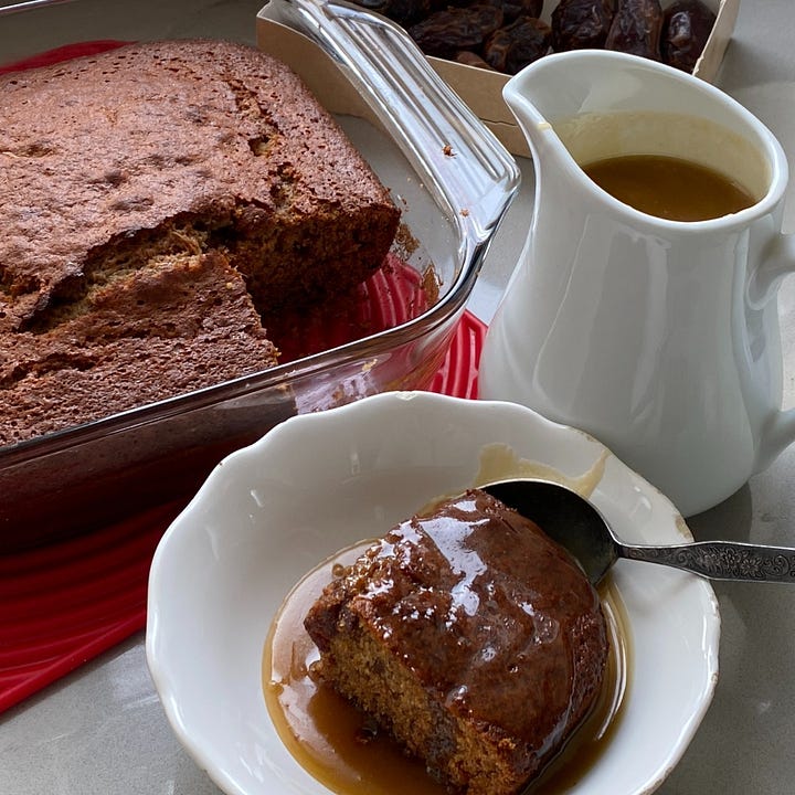 Dish of Sticky Toffee Pudding and a dish of thick vanilla custard.